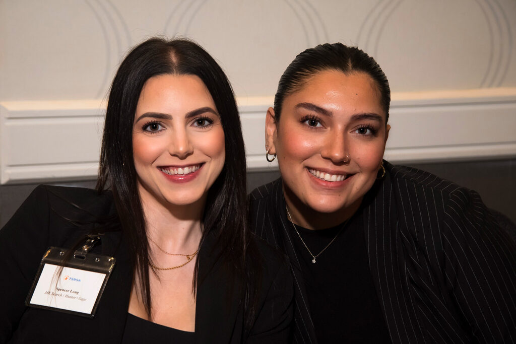 two smiling women at networking event